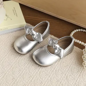 Elegant silver metallic girls princess shoes with bow detail and soft soles.