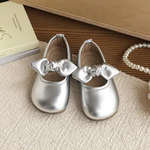 Elegant silver girl's princess shoes featuring a prominent bow design and soft sole