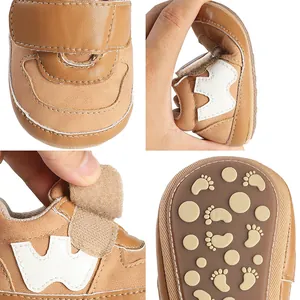 Detailed view of flexible brown baby walker shoes with non-slip sole and velcro strap