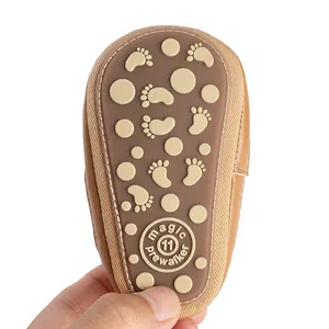 Close-up of brown non-slip rubber sole for baby pre-walker shoes with size 11 mark