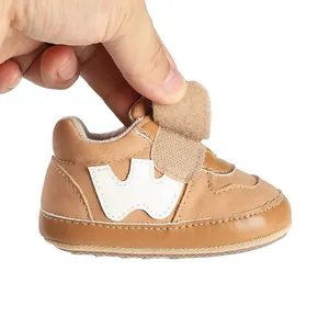Soft brown leather infant pre-walker sports shoe featuring an adjustable velcro strap
