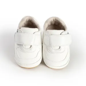Detailed front view of soft white faux leather baby pre-walker shoes with velcro