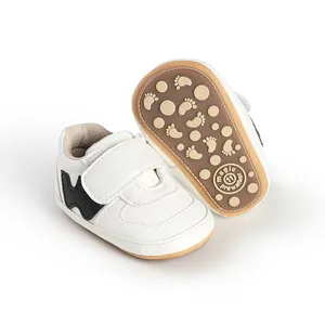 Detail of white baby walking shoes with velcro strap and non-slip rubber sole