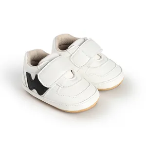 Detailed view of white baby sneakers with velcro straps for infants 0-1 year