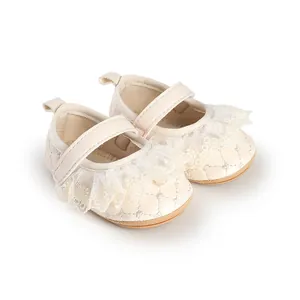 Detailed view of cream baby walking shoes with delicate lace ruffles and quilted pattern