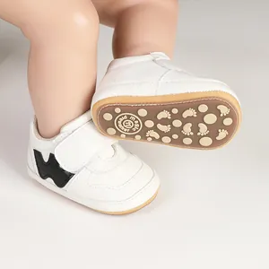 Detailed view of white baby prewalker shoes showing non-slip sole and hook-loop strap