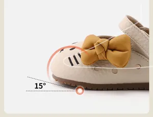 Close-up of baby girl walking shoe with yellow bow and 15-degree toe spring design.