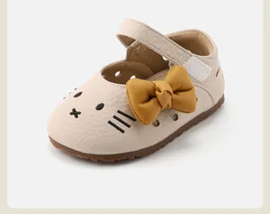 Detailed close-up view of a baby girl walking shoe with cat face and yellow bow
