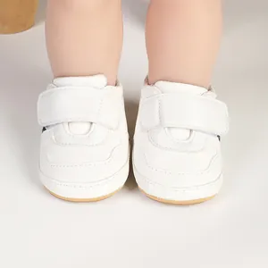 Detailed front view of white infant pre-walker sneakers with velcro strap closure