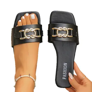 Women's black flat slides featuring a decorative gold chain and square toe design.
