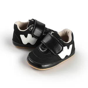 Close-up view of stylish black and white baby boy velcro sports walking shoes for infants