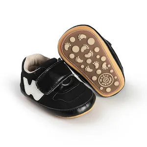 Bottom view of black baby walker shoes with non-slip sole and Velcro closure