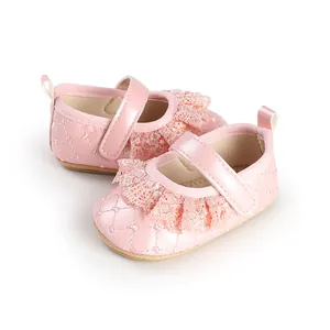 Detailed view of pink baby girl princess shoes with lace ruffles and quilted finish