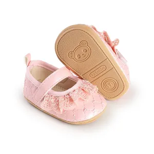 Detailed macro view of pink baby walking shoes featuring lace trim and quilted pattern details