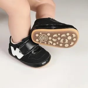 Close-up view of black baby sports pre-walker shoes with non-slip sole and velcro strap
