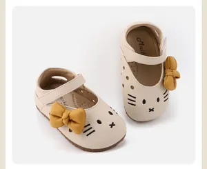 Detailed view of baby girl walking shoes with yellow bow and cat face design