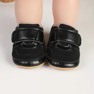 Macro view of black infant pre-walker sports shoes with synthetic leather and velcro straps