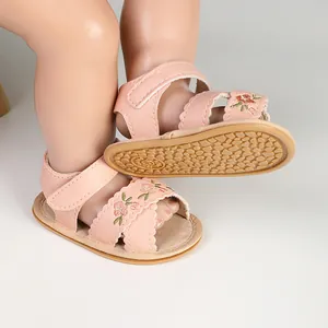 Detailed view of pink embroidered baby walking sandals featuring a non-slip textured sole