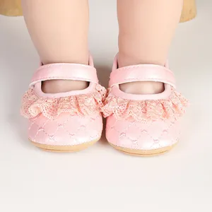 Close-up of pink baby princess walker shoes with delicate lace trim and quilted pattern.