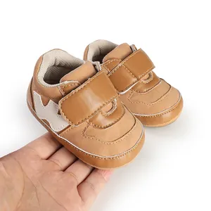 Detail view of brown faux leather baby sneakers with velcro strap