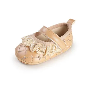 Close-up of beige baby walking shoes with lace ruffles and quilted heart pattern