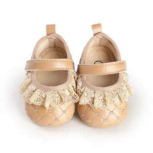 Close-up of beige quilted baby girl walking shoes with lace ruffles and velcro strap