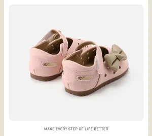 Close-up detail of pink baby girl toddler shoes featuring a cute decorative bow