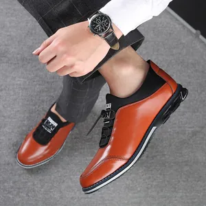 Close-up of stylish brown and black slip-on casual leather shoes worn by model.