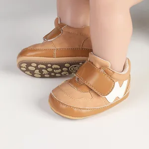 Detailed view of tan baby sports sneakers featuring a Velcro strap and a patterned non-slip sole.