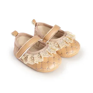 Detailed view of beige baby walking shoes with lace ruffle and quilted texture