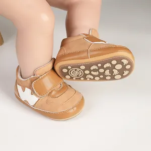 Detail showing the brown leather baby pre-walker shoe with non-slip sole