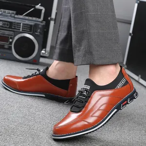 Brown leather casual sports shoes for men with slip-on design and contrast stitching details.