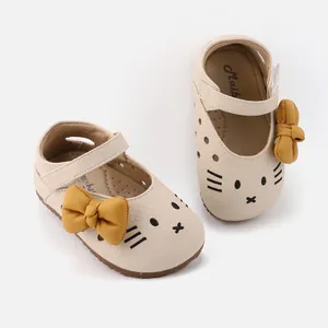 Adorable cream baby girl toddler shoes featuring cartoon cat face and a yellow bow