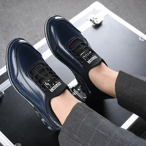 Close-up of navy blue men's casual slip-on leather shoes with elastic speed laces and plaid pants.