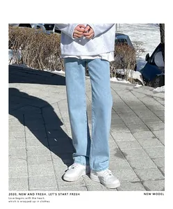 Close-up of men's light blue straight-leg summer jeans in a natural outdoor setting.