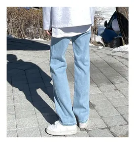 Rear view of men's light blue straight-leg denim jeans in a street setting