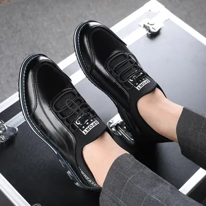Detailed top view of black casual leather shoes worn with trendy grey plaid trousers