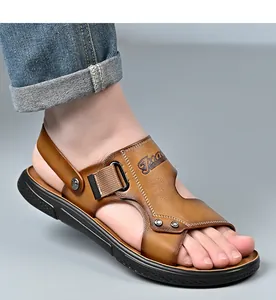 Close-up of brown leather men's casual sandals with adjustable strap on foot.