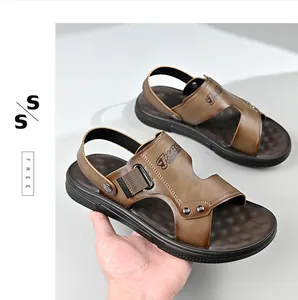 Close-up of stylish men's brown casual beach sandals with non-slip sole held by hand