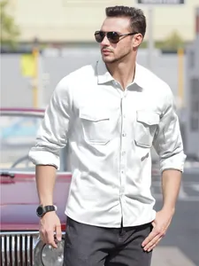 Close-up detail of men's white cotton linen long sleeve shirt with double flap chest pockets