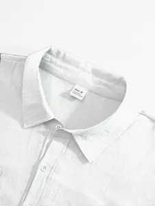 Close-up of men's white linen shirt collar showing fabric texture and size tag