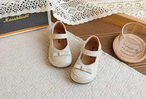 Chaussures Mary Jane beiges vintage pour filles avec un nœud élégant sur tapis tissé