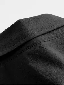 Macro detail view showing the breathable black cotton linen fabric of this men's casual shirt
