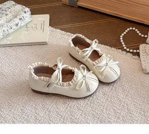 Detaillierte Ansicht eleganter cremefarbener Mary Jane Mädchenschuhe mit Spitze und Schleifen