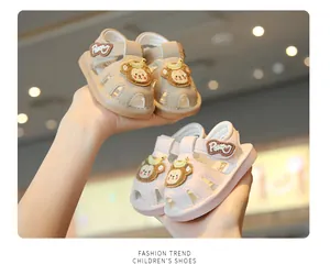 Close-up detail of cute cartoon baby walking sandals featuring closed-toe soft soles