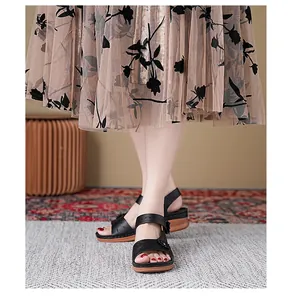 Detail view of women's black platform sandals with comfortable magic buckle design