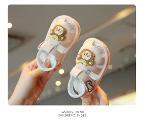 Close-up of pink cartoon monkey baby sandals with soft non-slip soles.