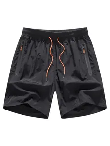 Pantalones cortos de playa negros de secado rápido con cordón naranja y bolsillos con cremallera