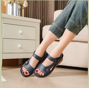 Macro view of comfortable navy blue platform sandals with flower accents worn indoors