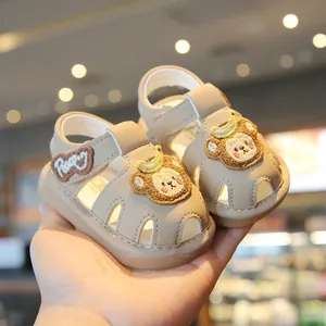 Cute beige baby toddler sandals with cartoon monkey design and closed-toe protection